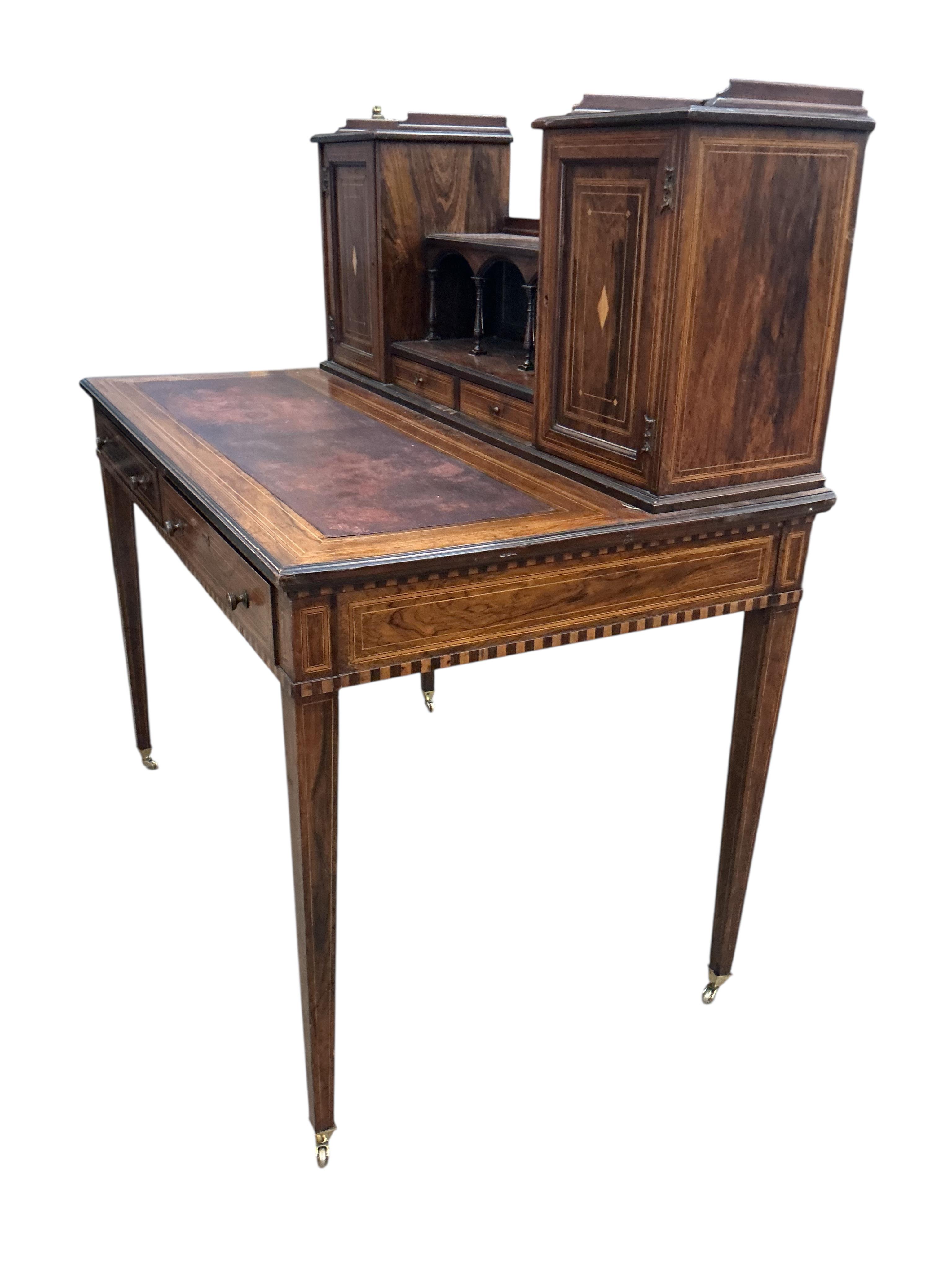 An Edwardian Edwards & Roberts inlaid rosewood desk, width 107cm, depth 66cm, height 114cm